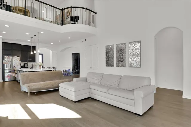 a living room with furniture and a view of kitchen