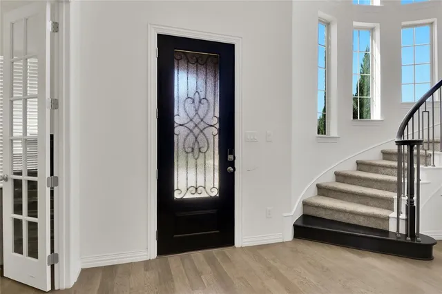 a view of a livingroom with entryway and stairs
