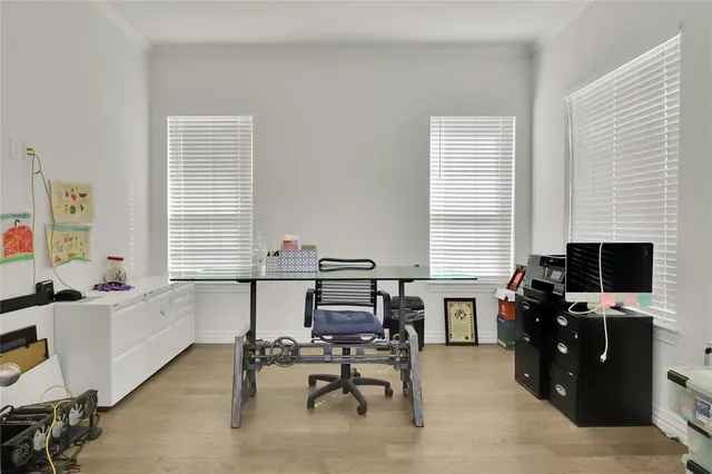 a view of a workspace with furniture and a window