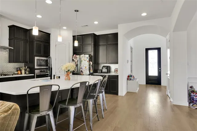 a large kitchen with a table and chairs