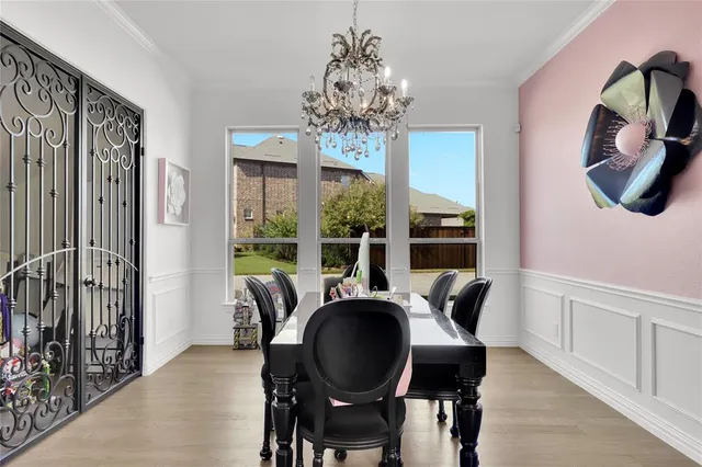 a dining room with furniture a chandelier and wooden floor
