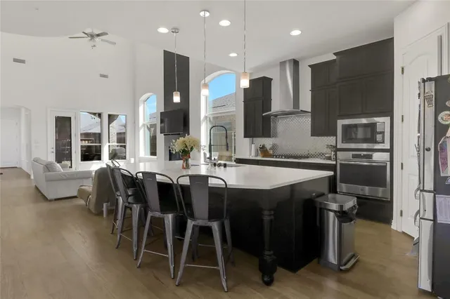a large kitchen with a table and chairs