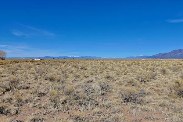 a view of a field with an ocean