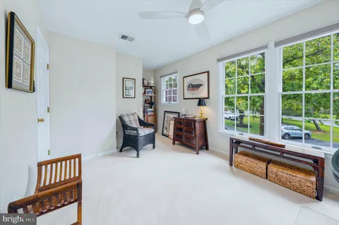 a bedroom with furniture and a large window