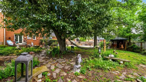 an aerial view of a house with a yard and garden