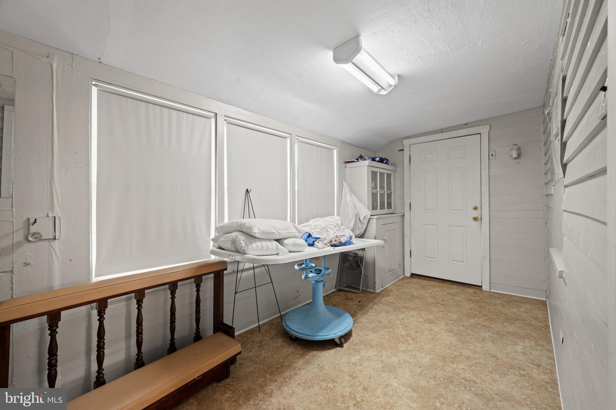 643 Main Street Leesburg, NJ 08327 - Photo 18 of 30 a room with lots of white furniture a chandelier and a window