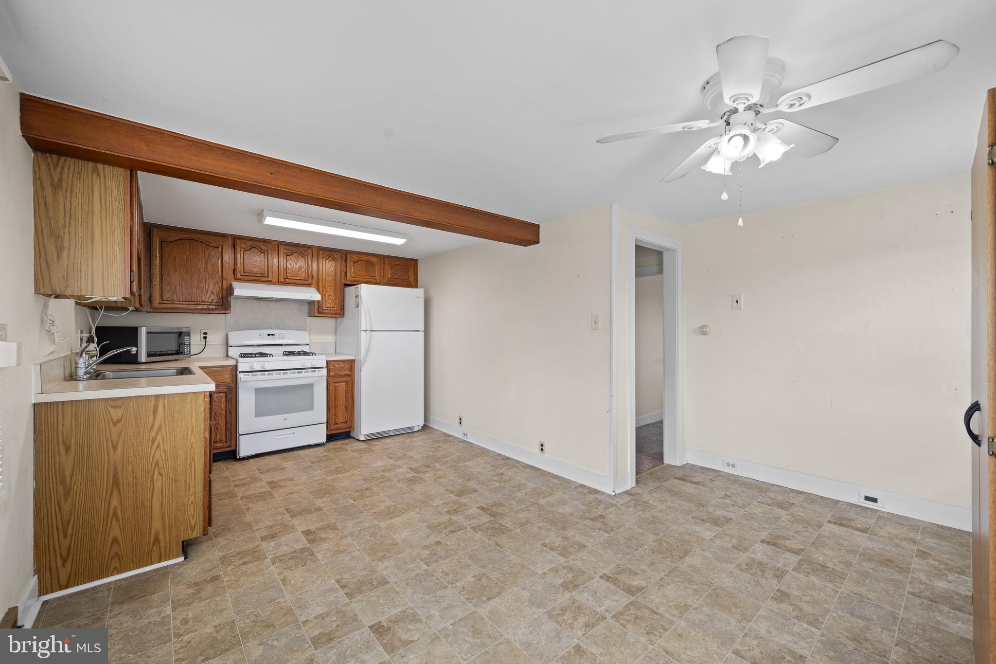643 Main Street Leesburg, NJ 08327 - Photo 27 of 30 a kitchen with a stove a sink and a refrigerator