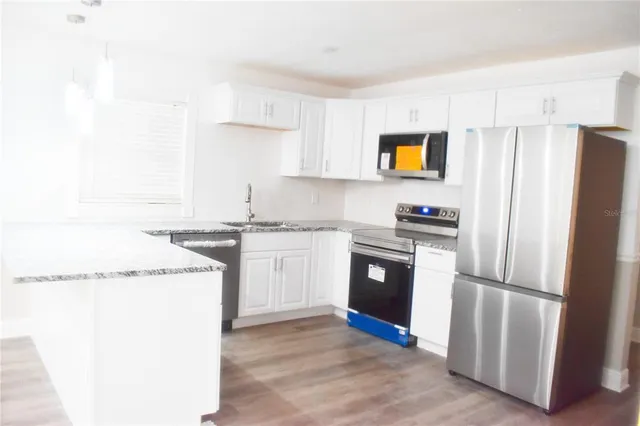 a kitchen with a refrigerator sink and stove