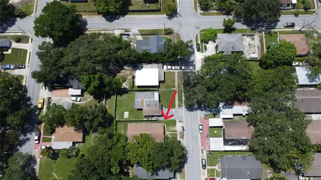 an aerial view of residential houses with outdoor space and street view