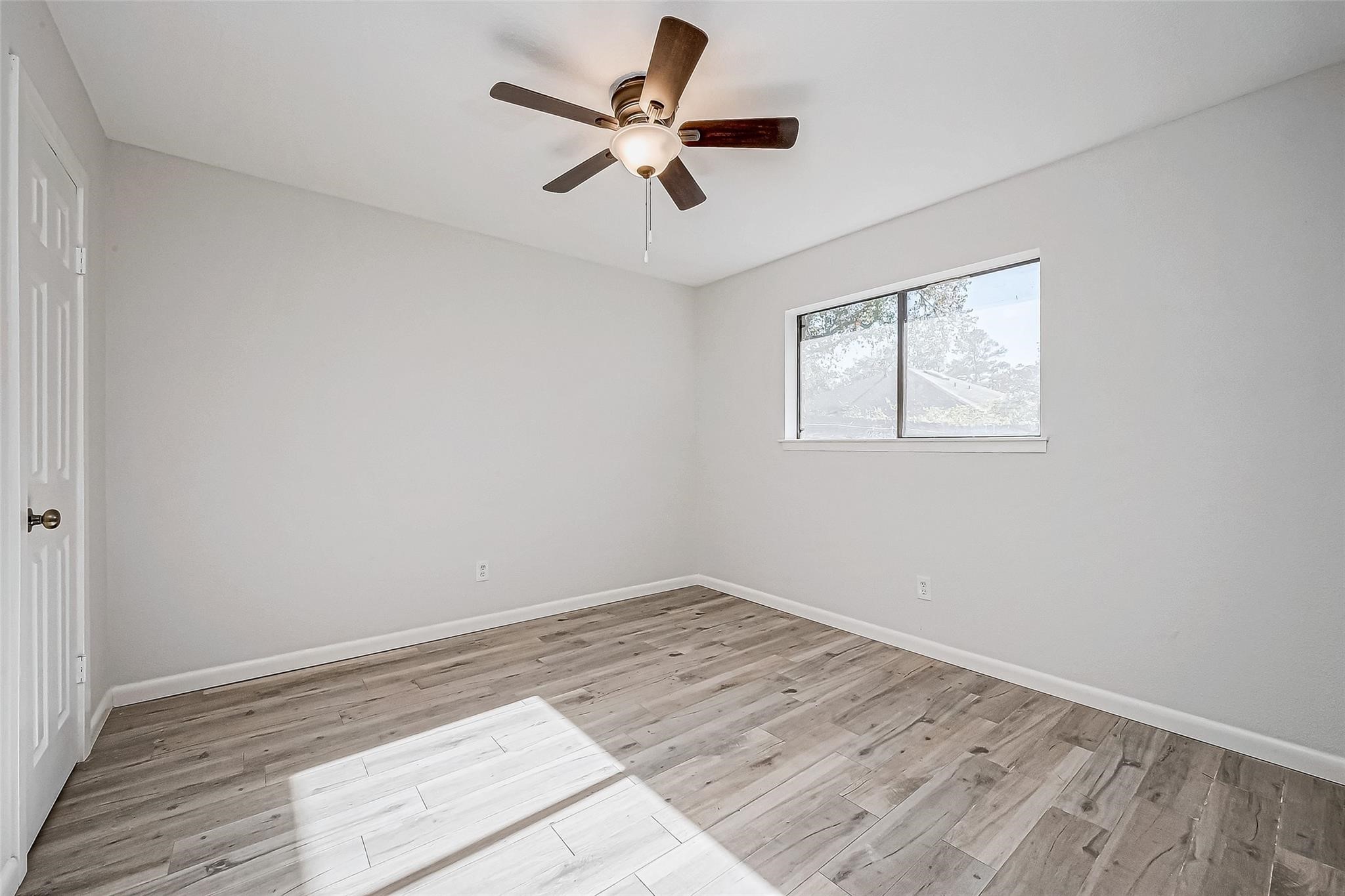 4907 Fox Hollow Boulevard Spring, TX 77389 - Photo 8 of 12 a view of empty room with wooden floor and ceiling fan