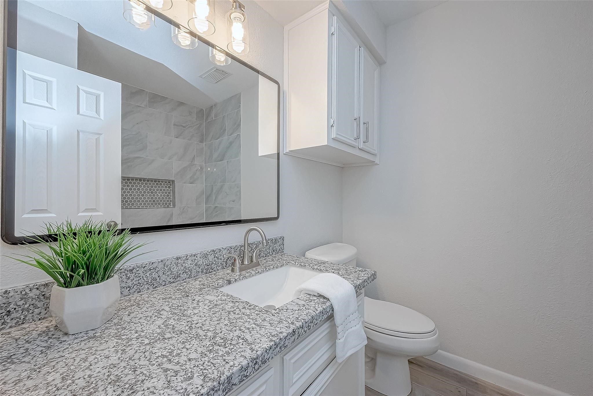 4907 Fox Hollow Boulevard Spring, TX 77389 - Photo 9 of 12 a bathroom with a granite countertop sink a toilet and a mirror