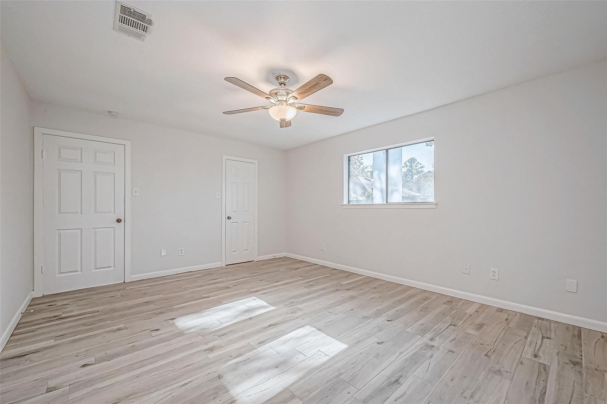 4907 Fox Hollow Boulevard Spring, TX 77389 - Photo 10 of 12 a view of empty room with wooden floor and fan