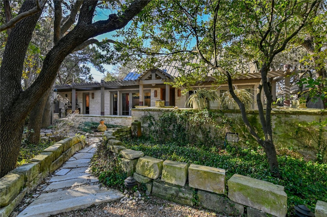 a view of backyard with seating space and trees