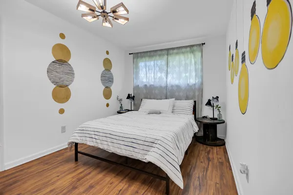 a bedroom with a bed dresser and a window