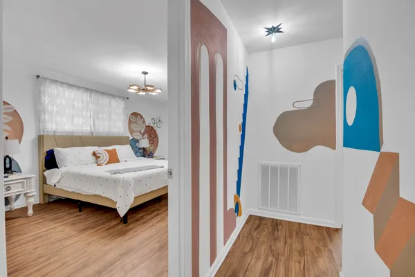 a bedroom with a bed and a mirror