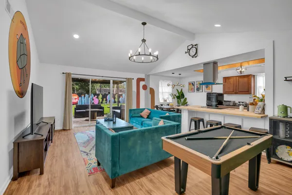 a living room with furniture a rug and a flat screen tv