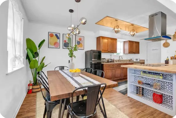 a kitchen with stainless steel appliances granite countertop a stove a sink dishwasher and cabinets with wooden floor