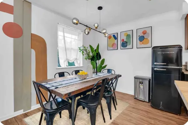 a view of a dining room with furniture window and wooden floor