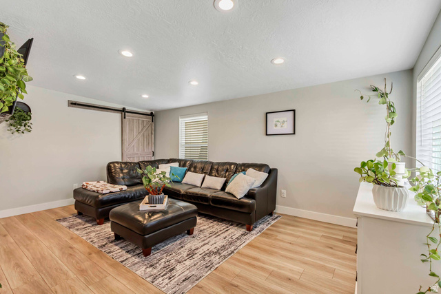 48 Moon Ridge Drive Murray, UT 84107 - Photo 4 of 30 Living space featuring wood-finish flooring, recessed lighting, and a barn door