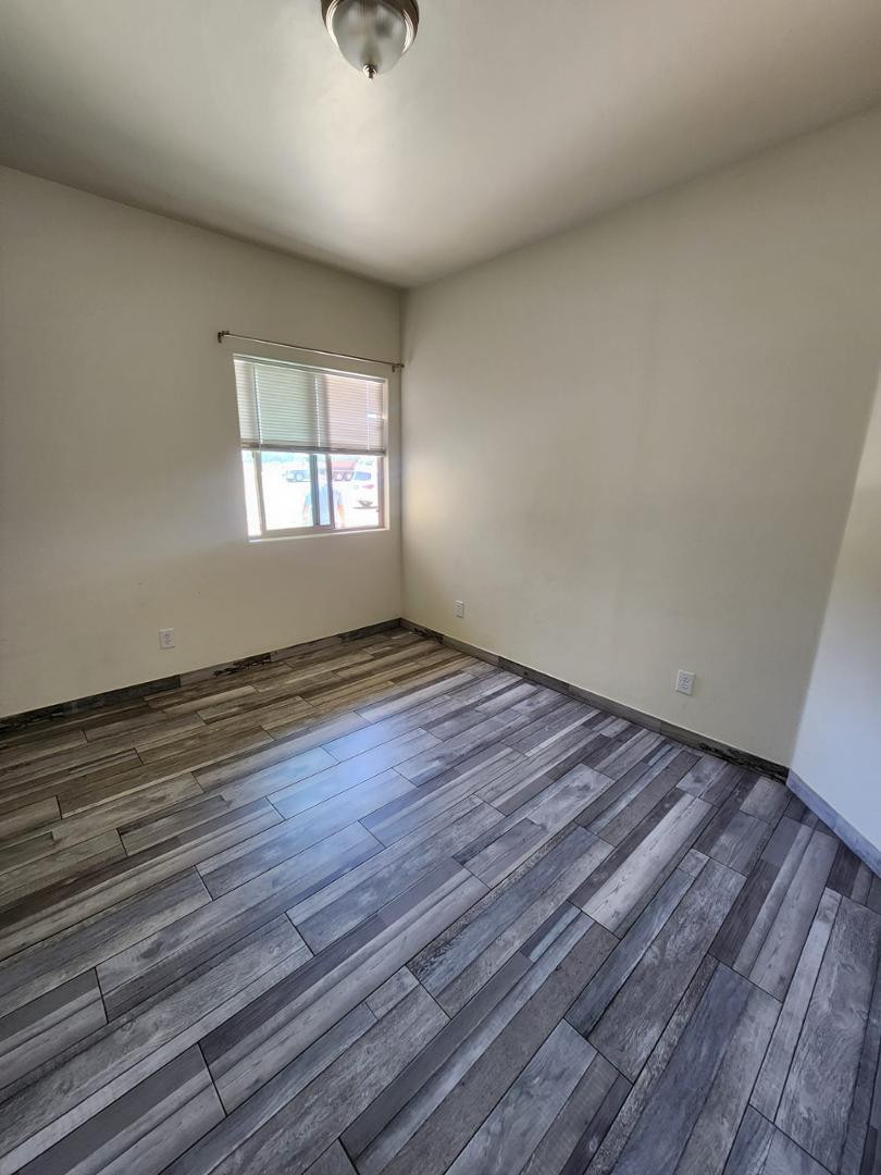 3641 Camino Del Rancho Douglas, AZ 85607 - Photo 5 of 20 wooden floor in an empty room with a window