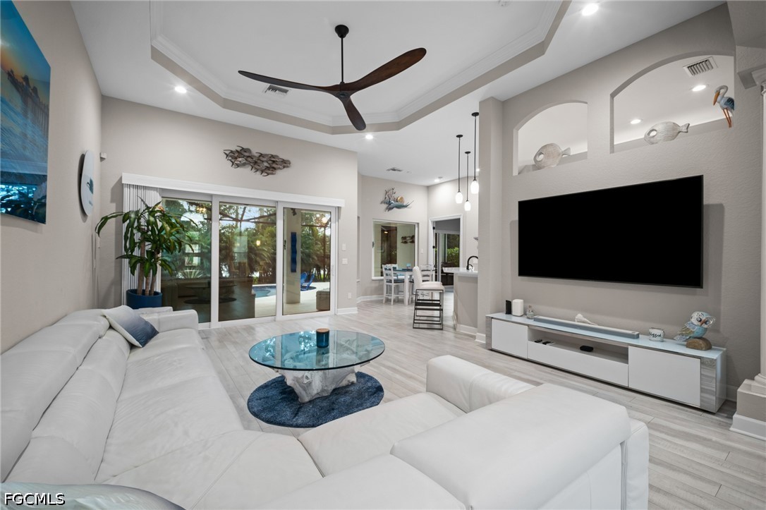 9042 Bronco Court Naples, FL 34113 - Photo 5 of 50 a living room with furniture and a flat screen tv