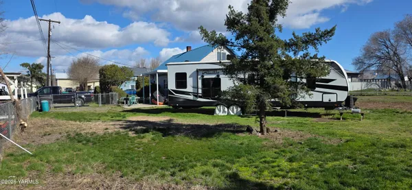 a view of a house with a yard and sitting area