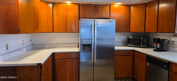 a kitchen with a refrigerator and cabinets