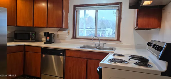 a kitchen with a refrigerator and cabinets