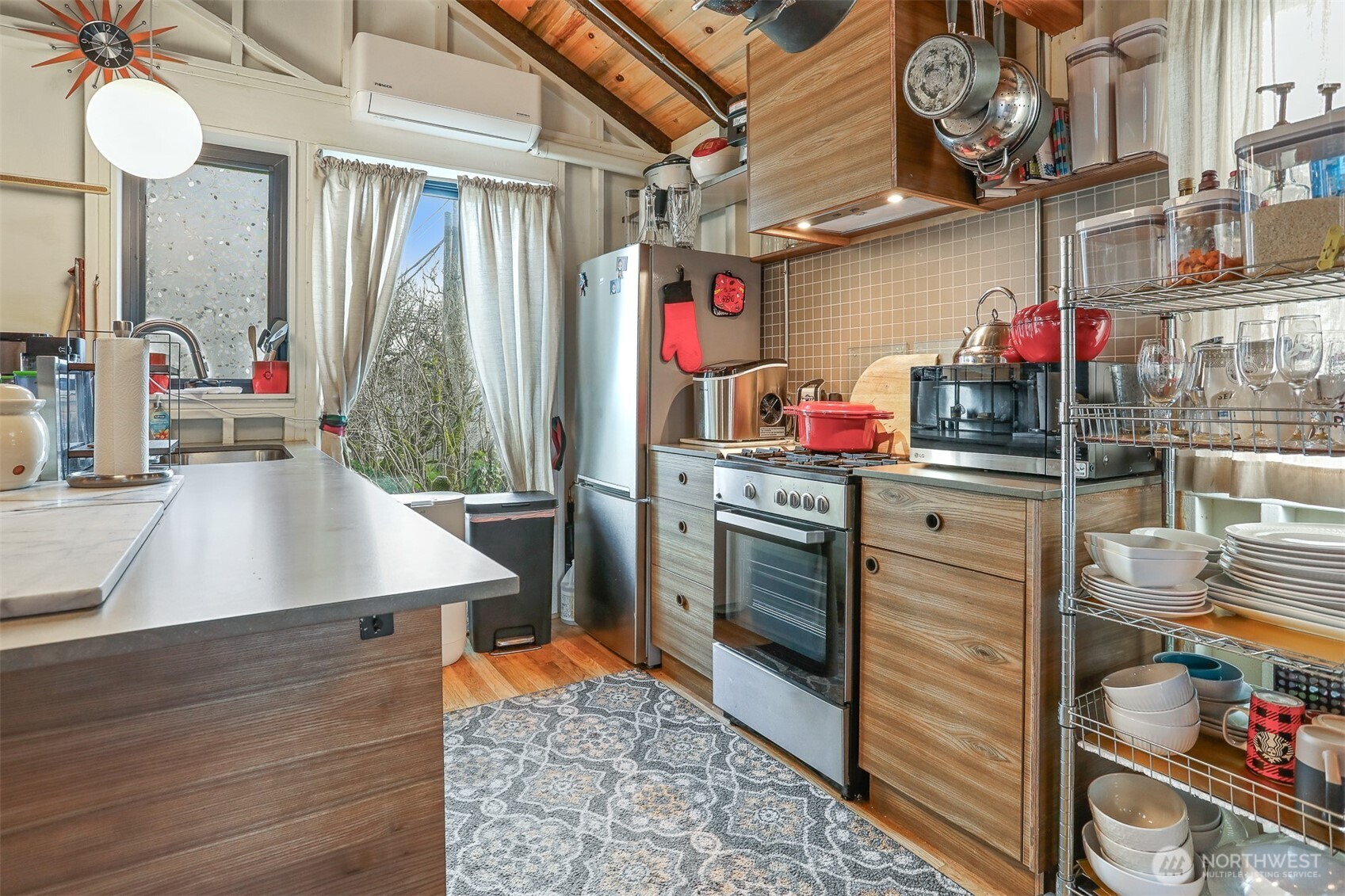 3868 16th Avenue Southwest Seattle, WA 98106 - Photo 14 of 37 a kitchen with stainless steel appliances granite countertop a sink dishwasher and a stove next to a window