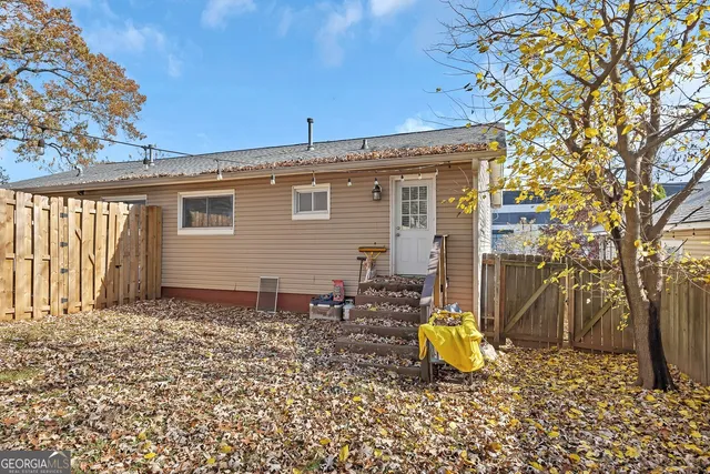 a backyard of a house with table and chairs