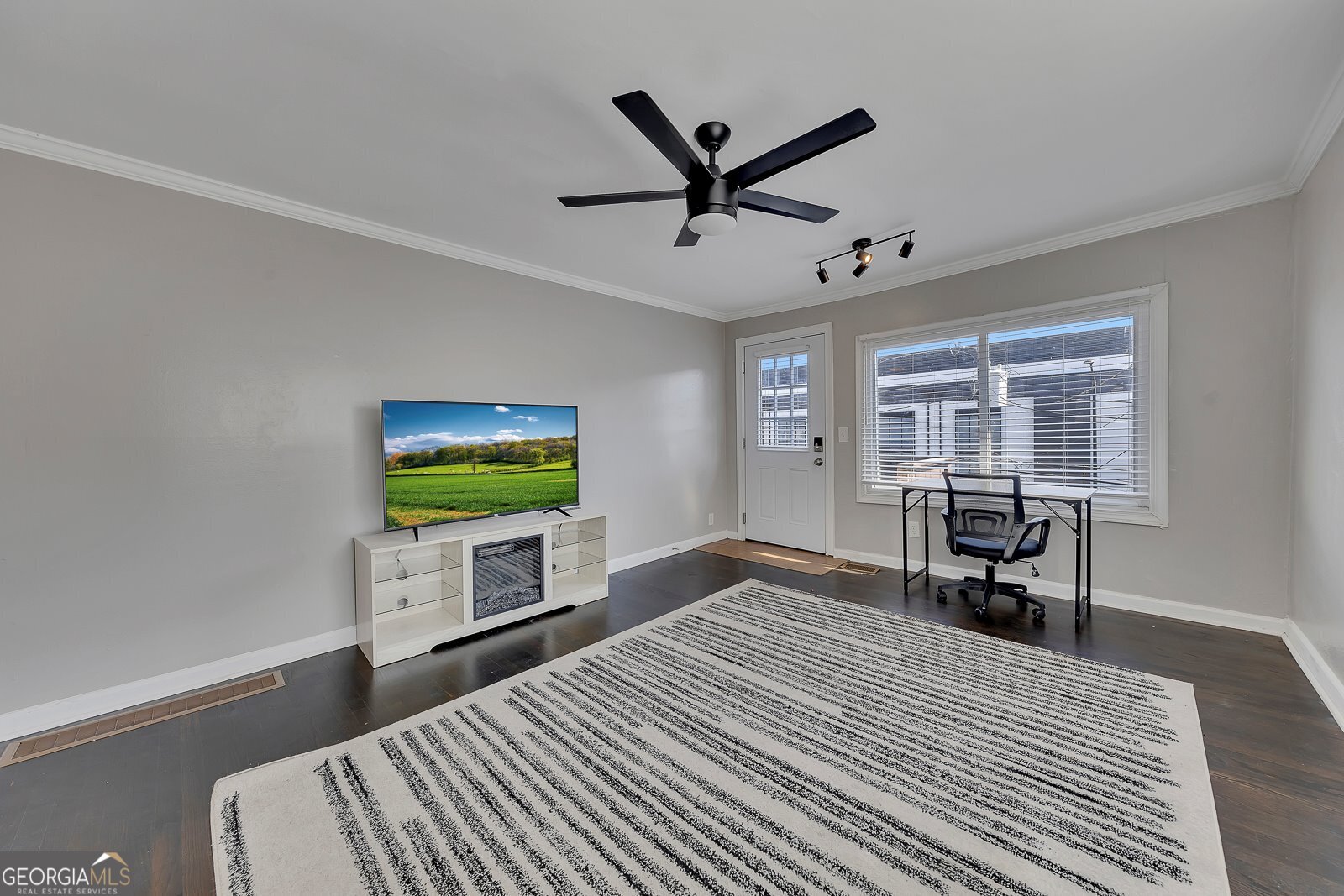 1040 Herndon Street Northwest, Unit A Atlanta, GA 30318 - Photo 5 of 28 a bedroom with a bed and a flat screen tv