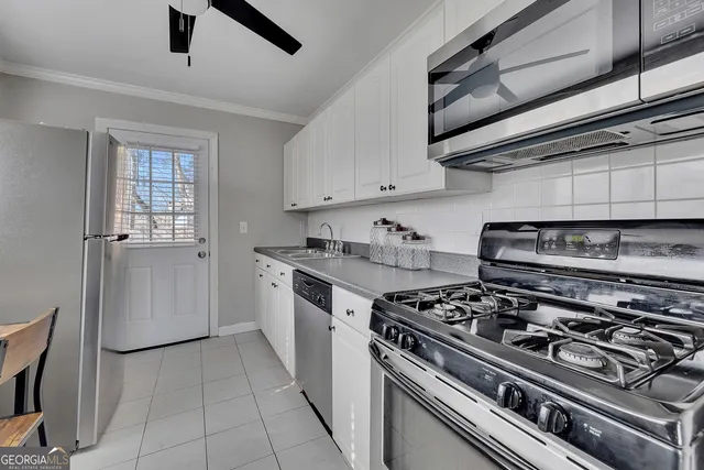 a kitchen with a stove and a refrigerator