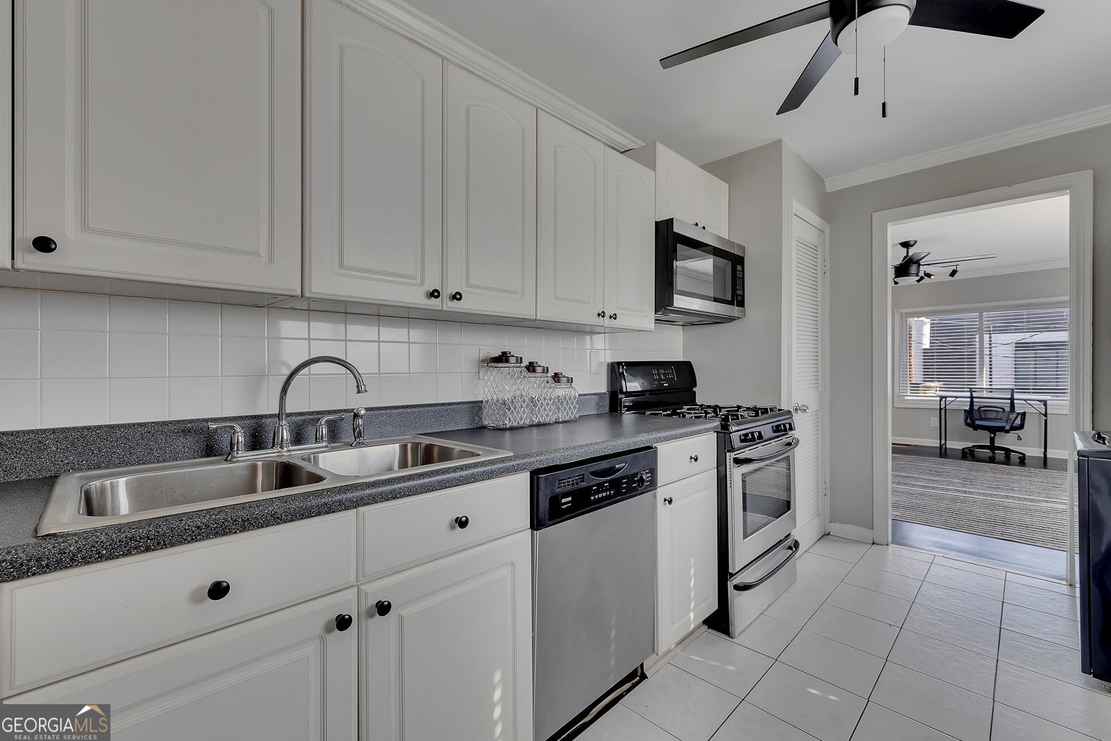 1040 Herndon Street Northwest, Unit A Atlanta, GA 30318 - Photo 10 of 28 a kitchen with granite countertop a sink stainless steel appliances and cabinets