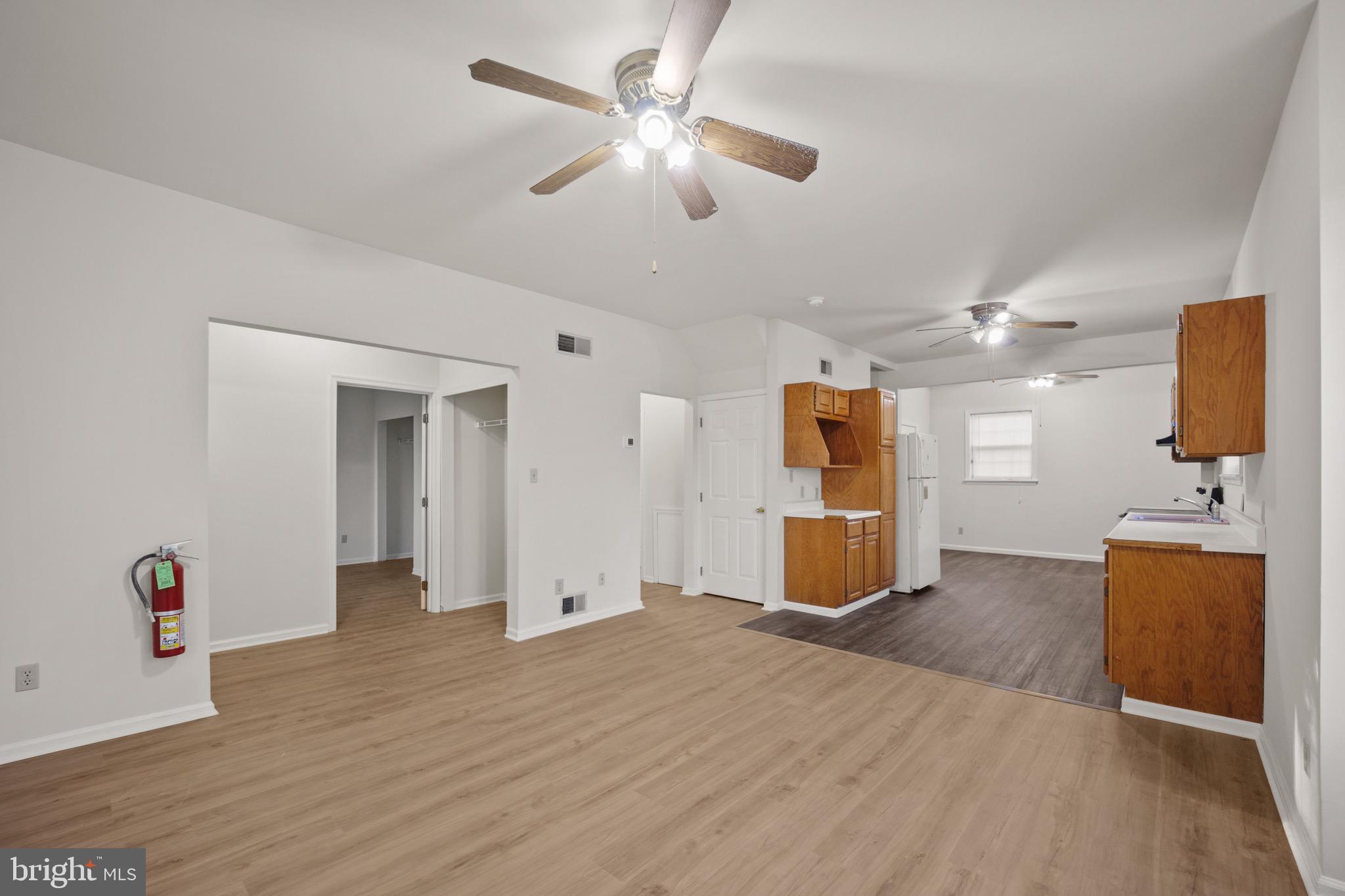 4040 Concord Road Aston, PA 19014 - Photo 5 of 22 an empty room with wooden floor and ceiling fan