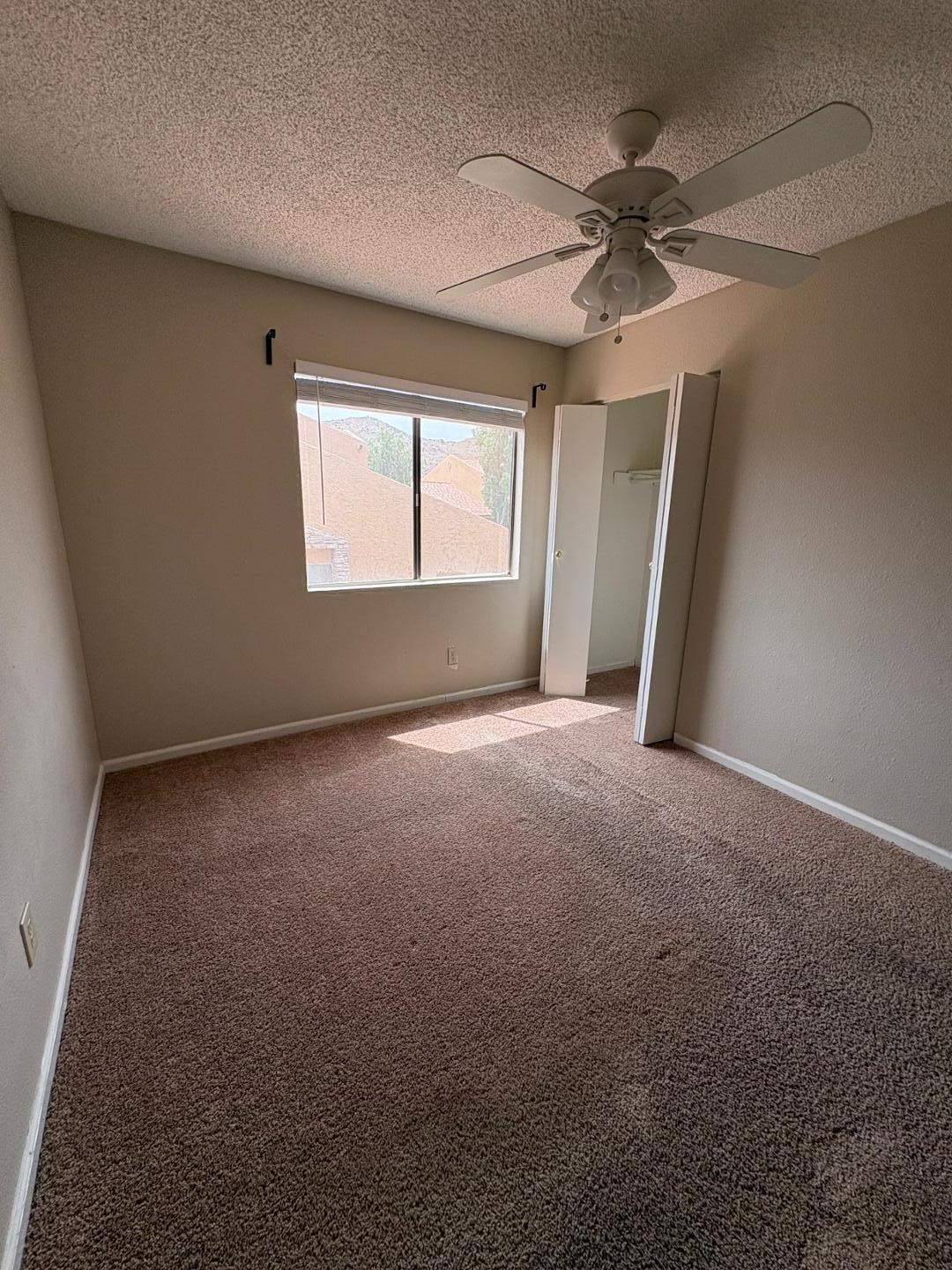 3511 East Baseline Road, Unit 1041 Phoenix, AZ 85042 - Photo 4 of 5 a view of a livingroom with a ceiling fan and window