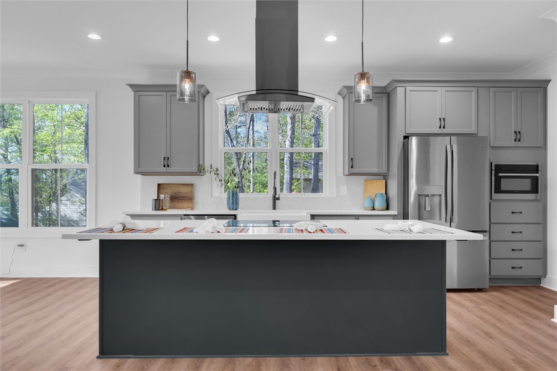 407 Blue Ridge Court Westminster, SC 29693 - Photo 9 of 48 This kitchen features a central island, modern appliances, and abundant natural light.