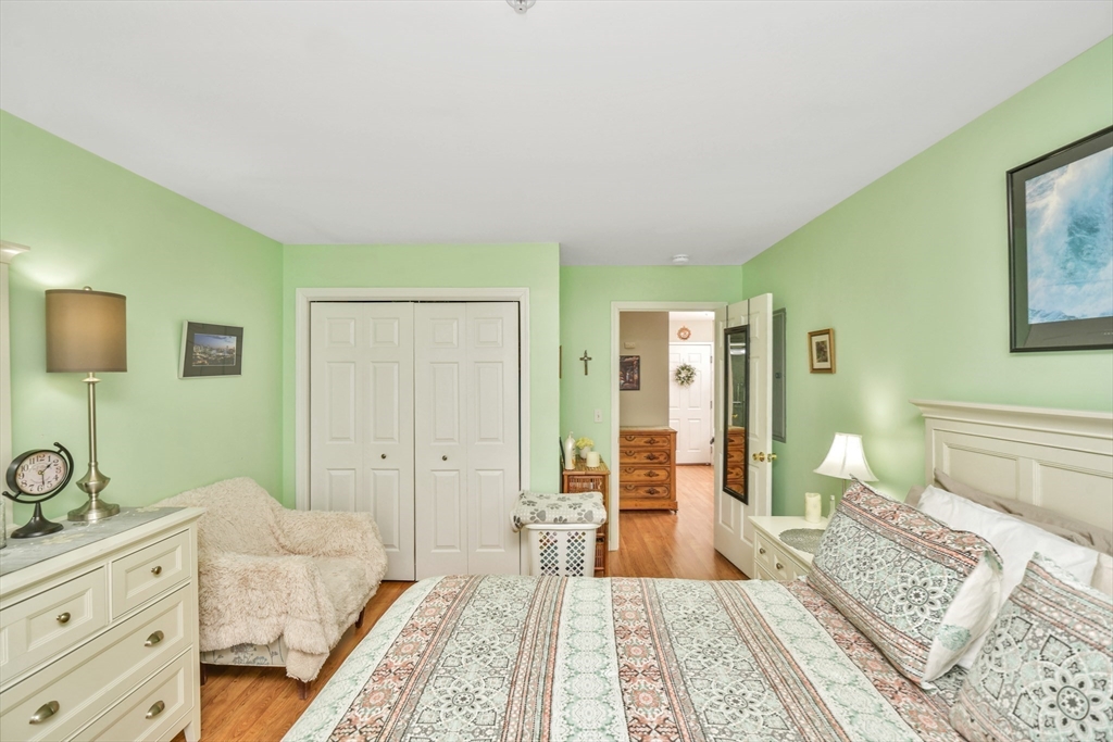 75 Walnut Street, Unit 315 Peabody, MA 01960 - Photo 11 of 14 a spacious bedroom with a bed and a dresser