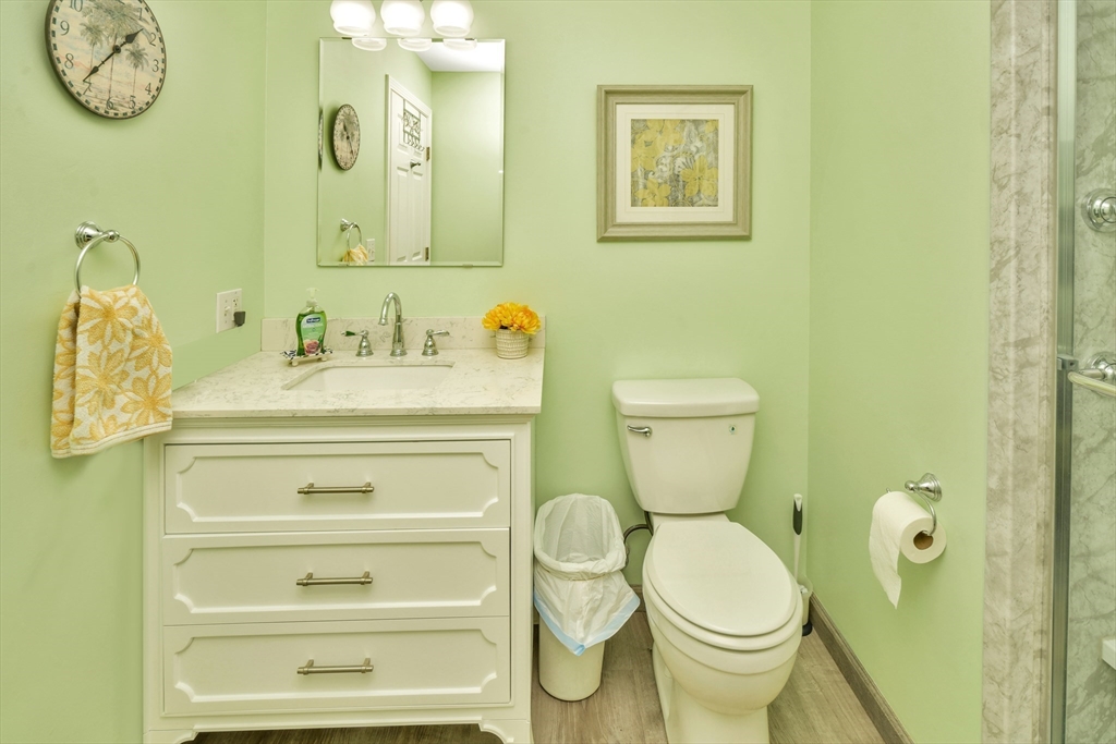 75 Walnut Street, Unit 315 Peabody, MA 01960 - Photo 13 of 14 a bathroom with a toilet sink and mirror