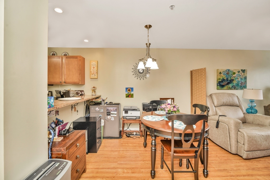 75 Walnut Street, Unit 315 Peabody, MA 01960 - Photo 5 of 14 a view of a dining room with furniture and wooden floor
