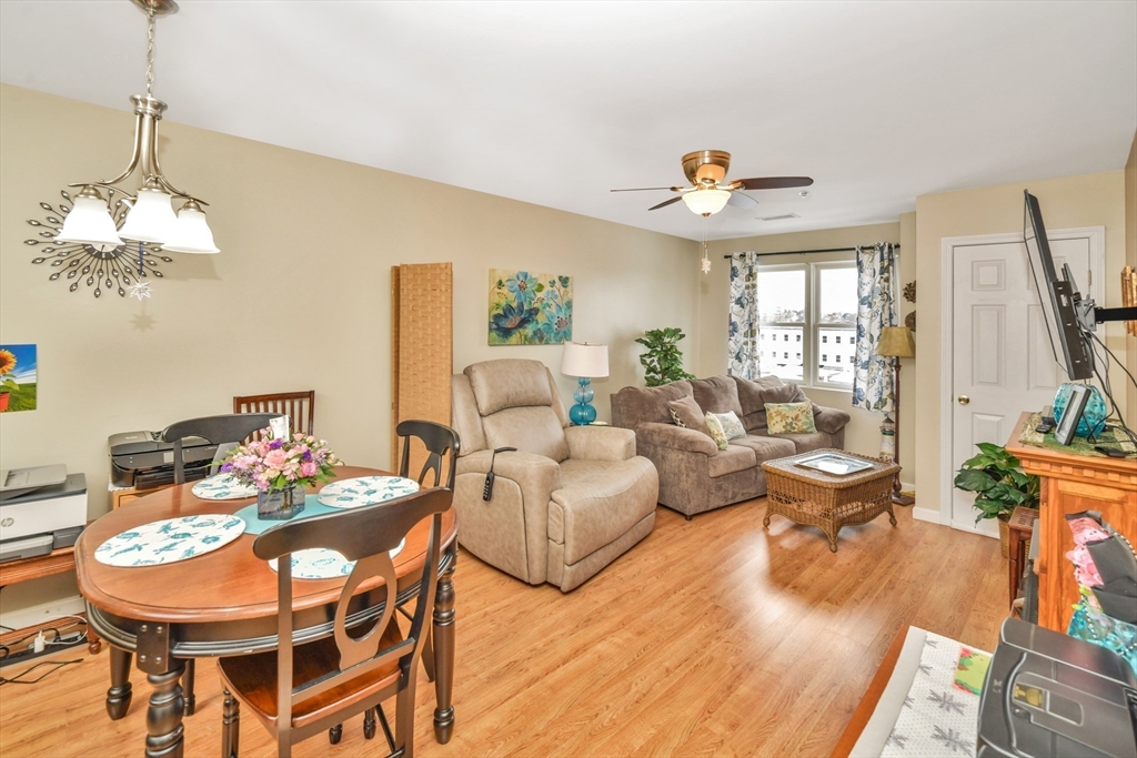 75 Walnut Street, Unit 315 Peabody, MA 01960 - Photo 6 of 14 a living room with fireplace furniture and a chandelier