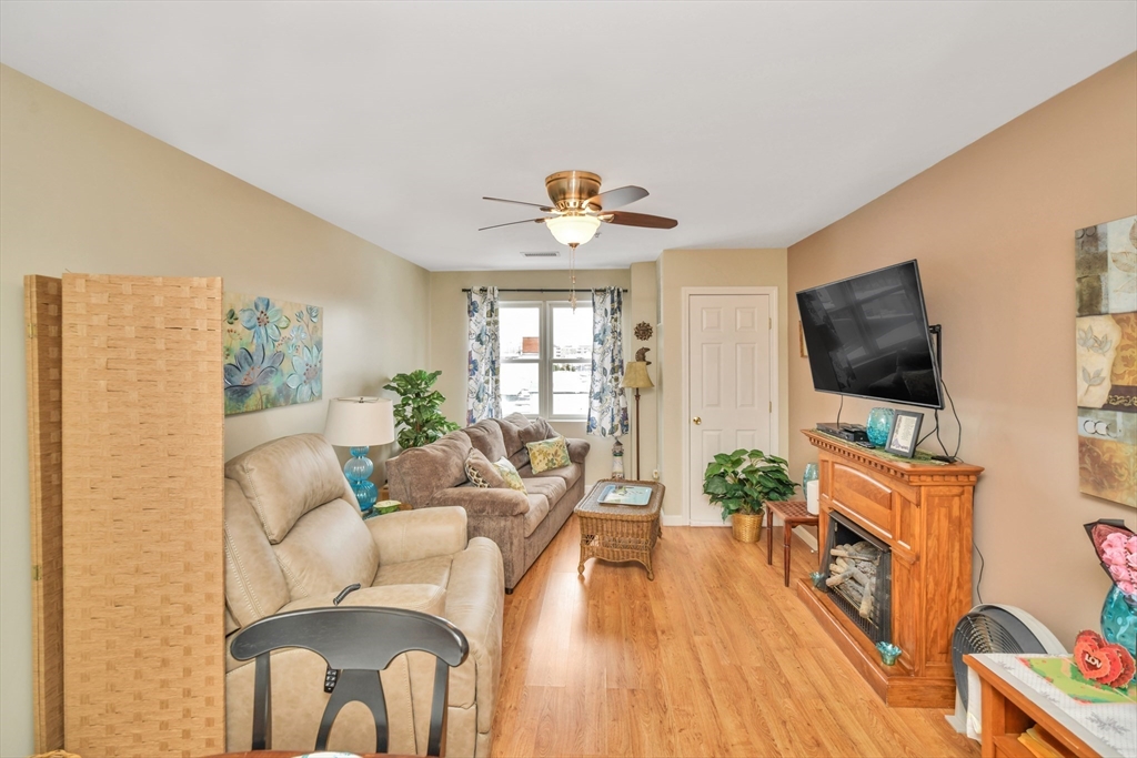 75 Walnut Street, Unit 315 Peabody, MA 01960 - Photo 7 of 14 a living room with furniture a flat screen tv and a flat screen tv