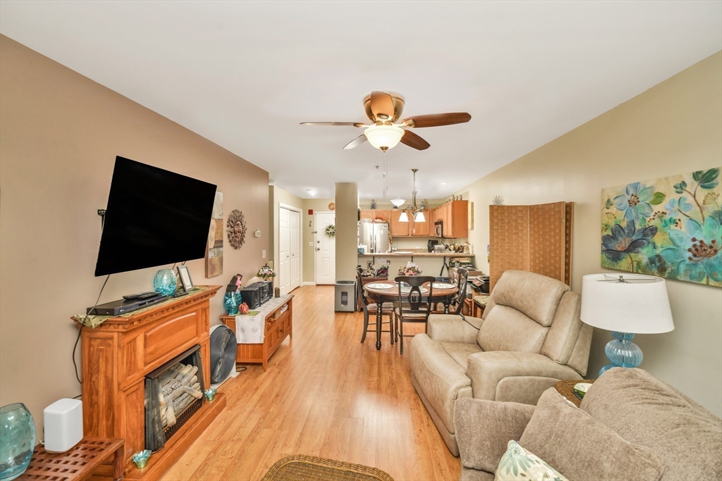 75 Walnut Street, Unit 315 Peabody, MA 01960 - Photo 8 of 14 a living room with furniture and a flat screen tv