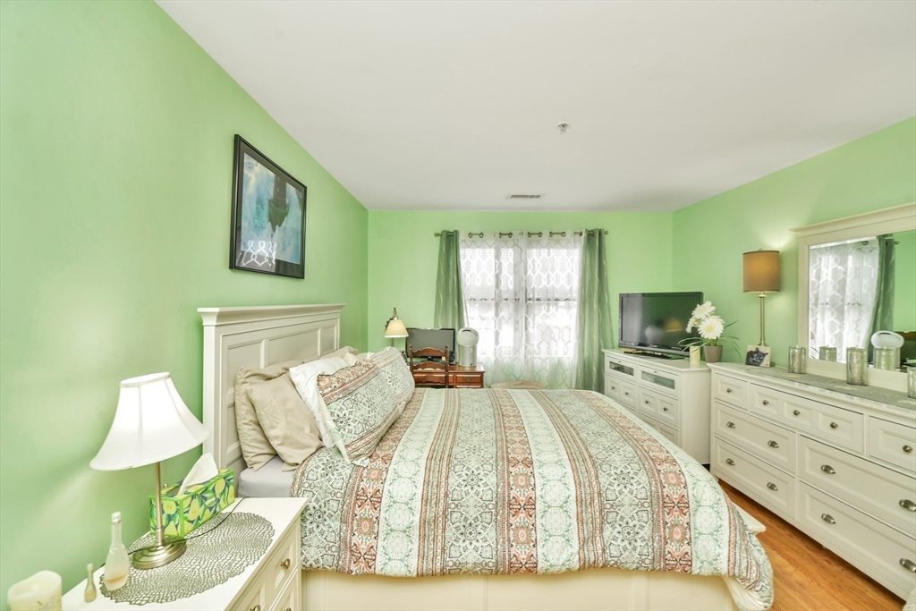 75 Walnut Street, Unit 315 Peabody, MA 01960 - Photo 9 of 14 a spacious bedroom with a bed and a dresser