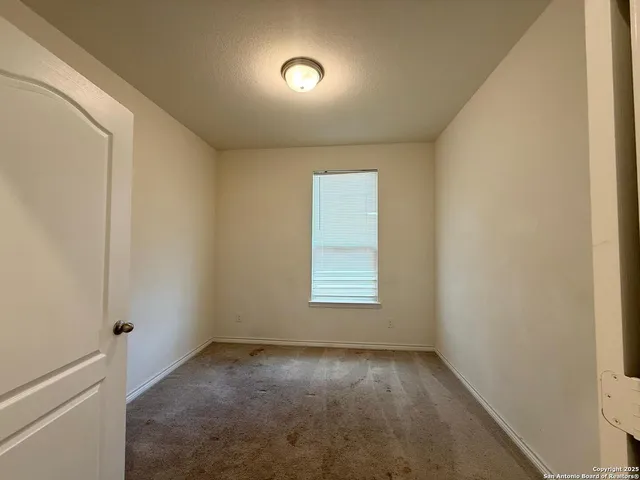 a view of an empty room and a window