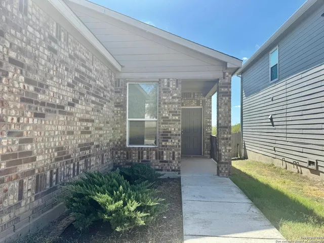 a porch with seating space and yard in back
