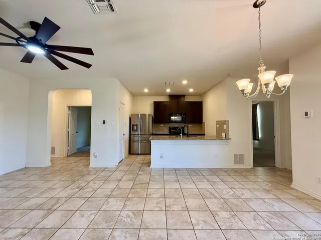 a view of a electric appliances and living room with a chandelier