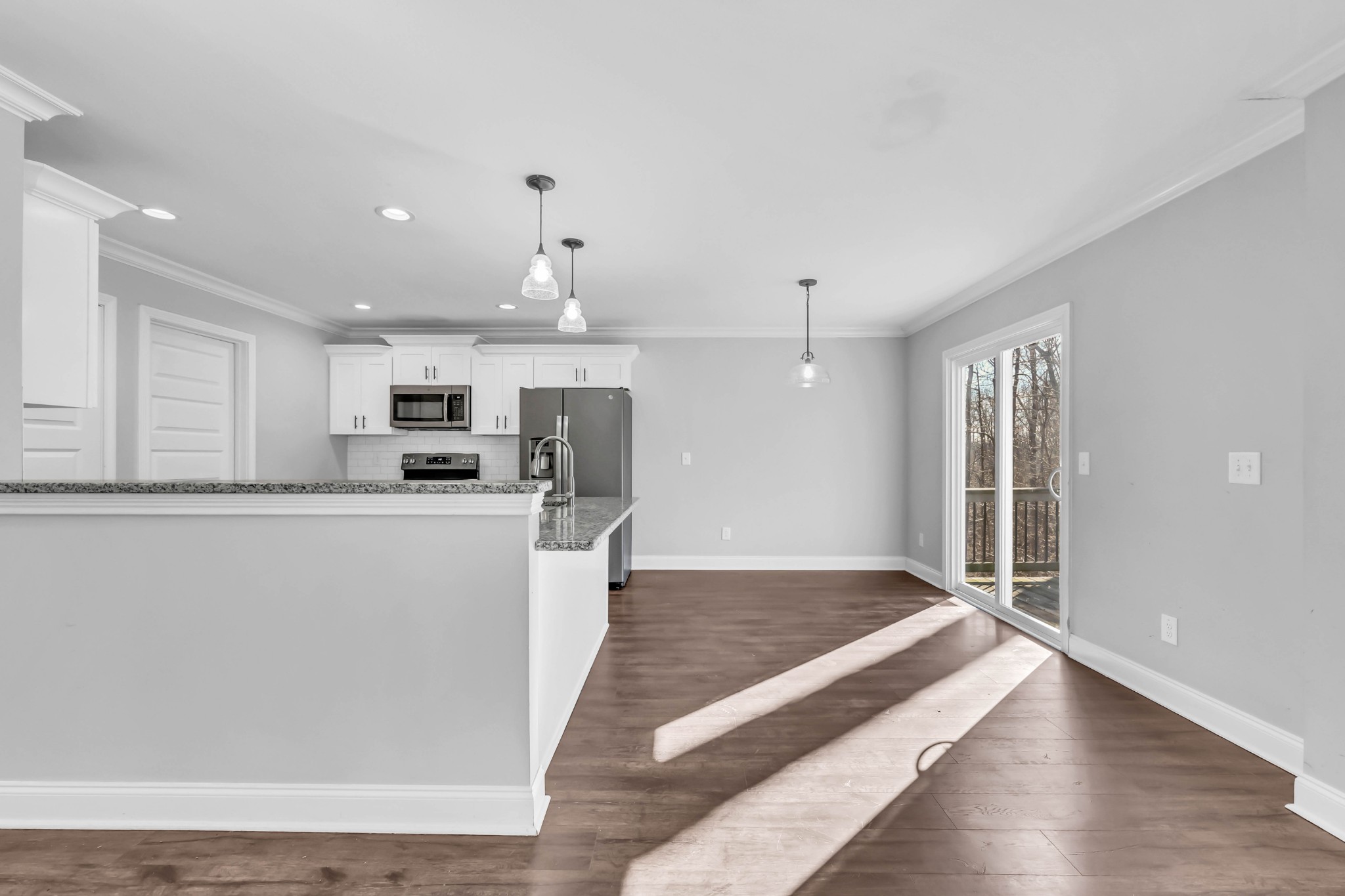 2320 Bearden Road Clarksville, TN 37043 - Photo 14 of 44 a large white kitchen with kitchen island a sink wooden floor and stainless steel appliances