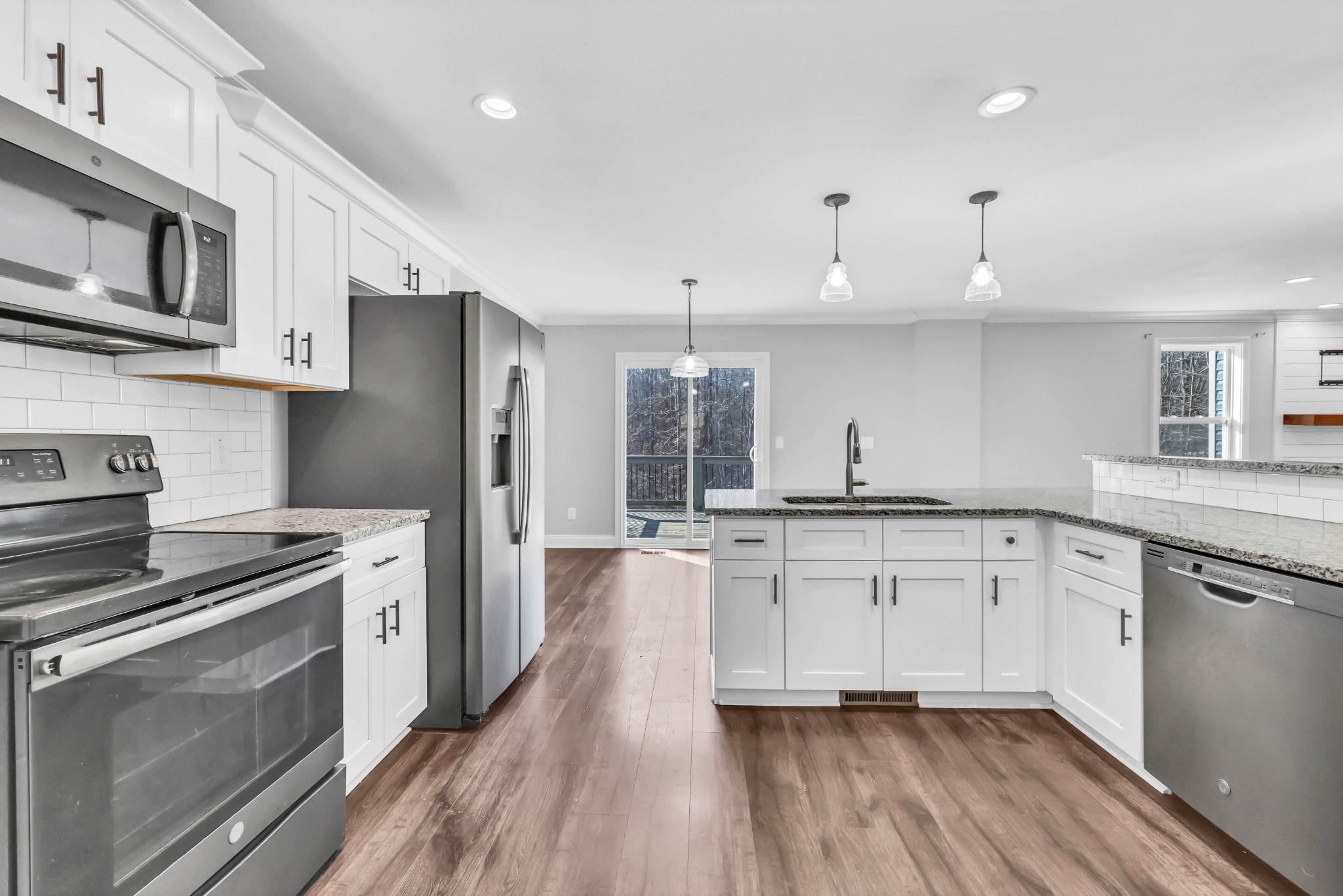 2320 Bearden Road Clarksville, TN 37043 - Photo 19 of 44 a kitchen with stainless steel appliances granite countertop a stove a sink and a refrigerator