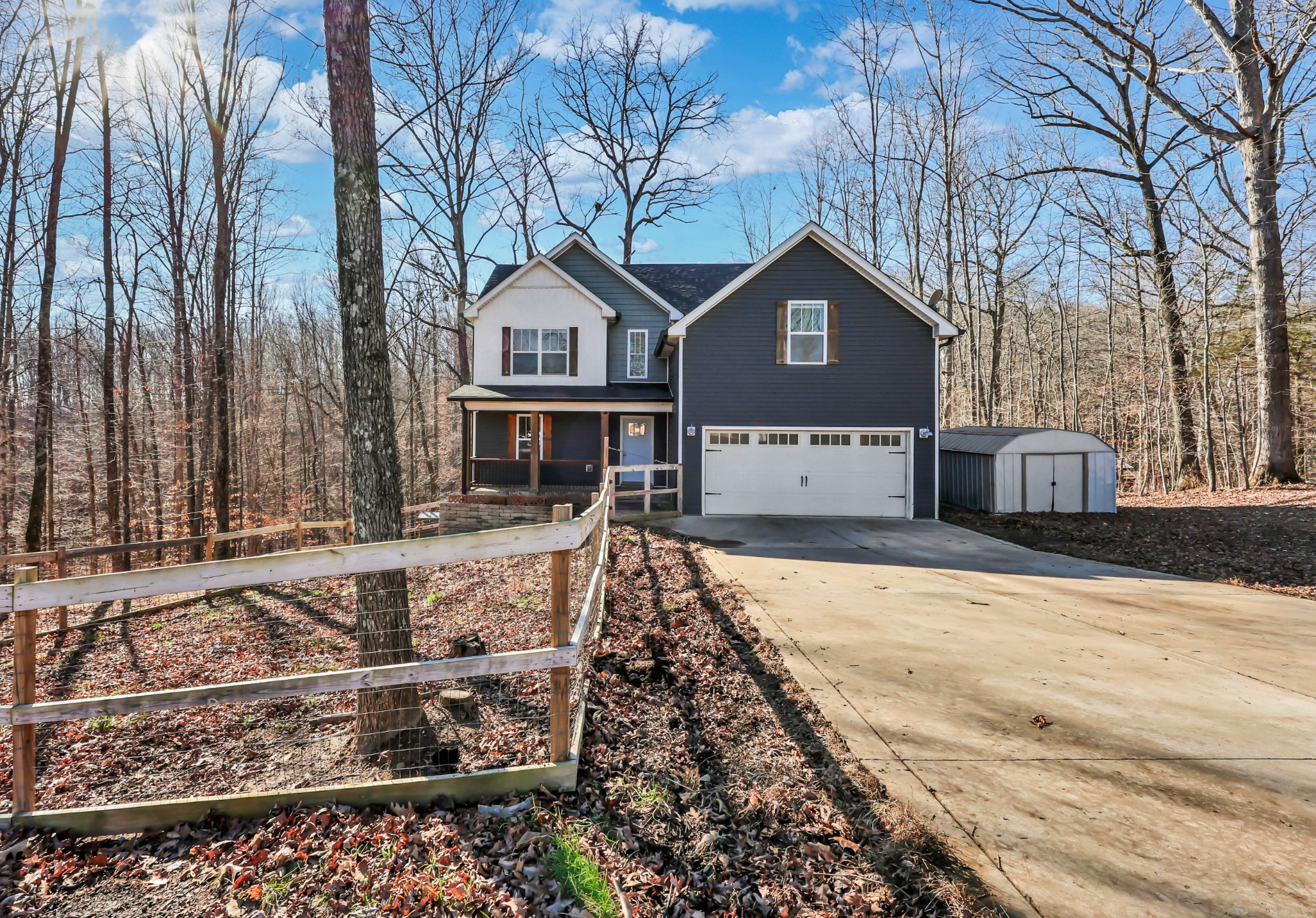 2320 Bearden Road Clarksville, TN 37043 - Photo 2 of 44 a front view of a house with parking yard and covered with snow