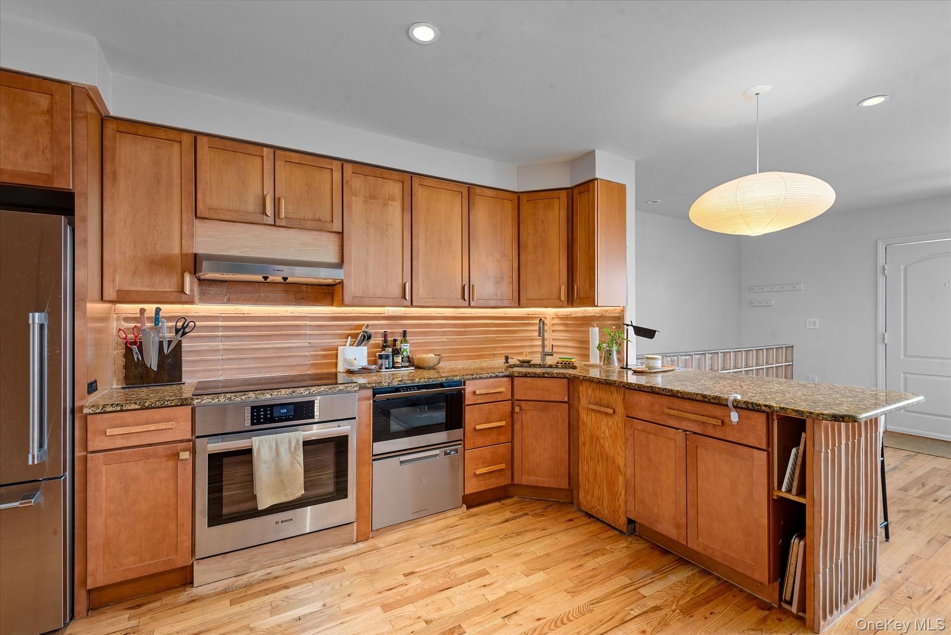 100-12 Shore Front Parkway, Unit 18A Queens, NY 11694 - Photo 15 of 37 a kitchen with stainless steel appliances granite countertop a stove a sink dishwasher and a refrigerator